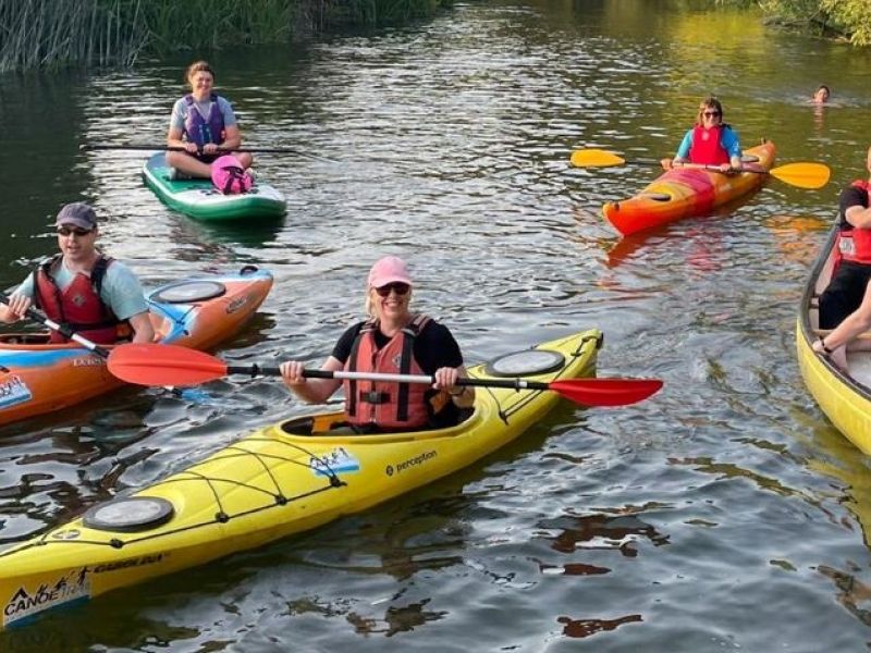 People on the River in Kayaks and Canoes