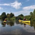 Sunny Day on the River in Kayaks and Canoes