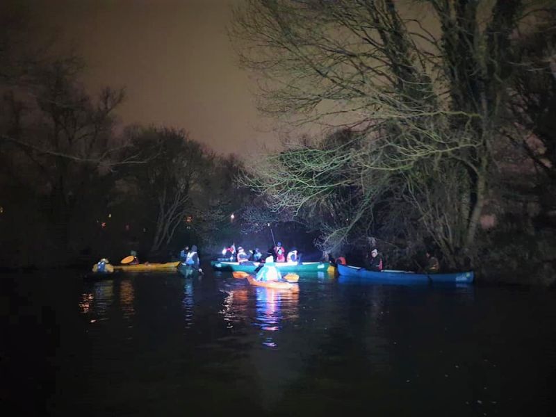 At night on the river in canoes and kayaks on Burns Night