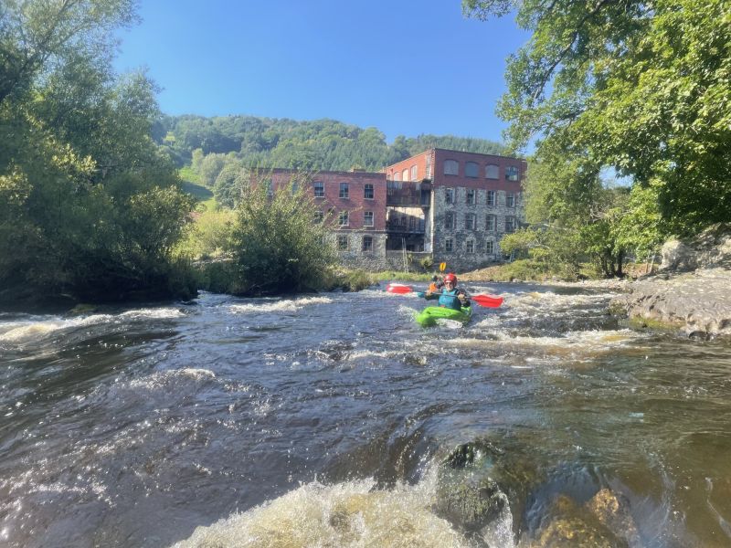 Running the rapids on the Dee Loop in kayaks on our 2 day Intro to White Water Course